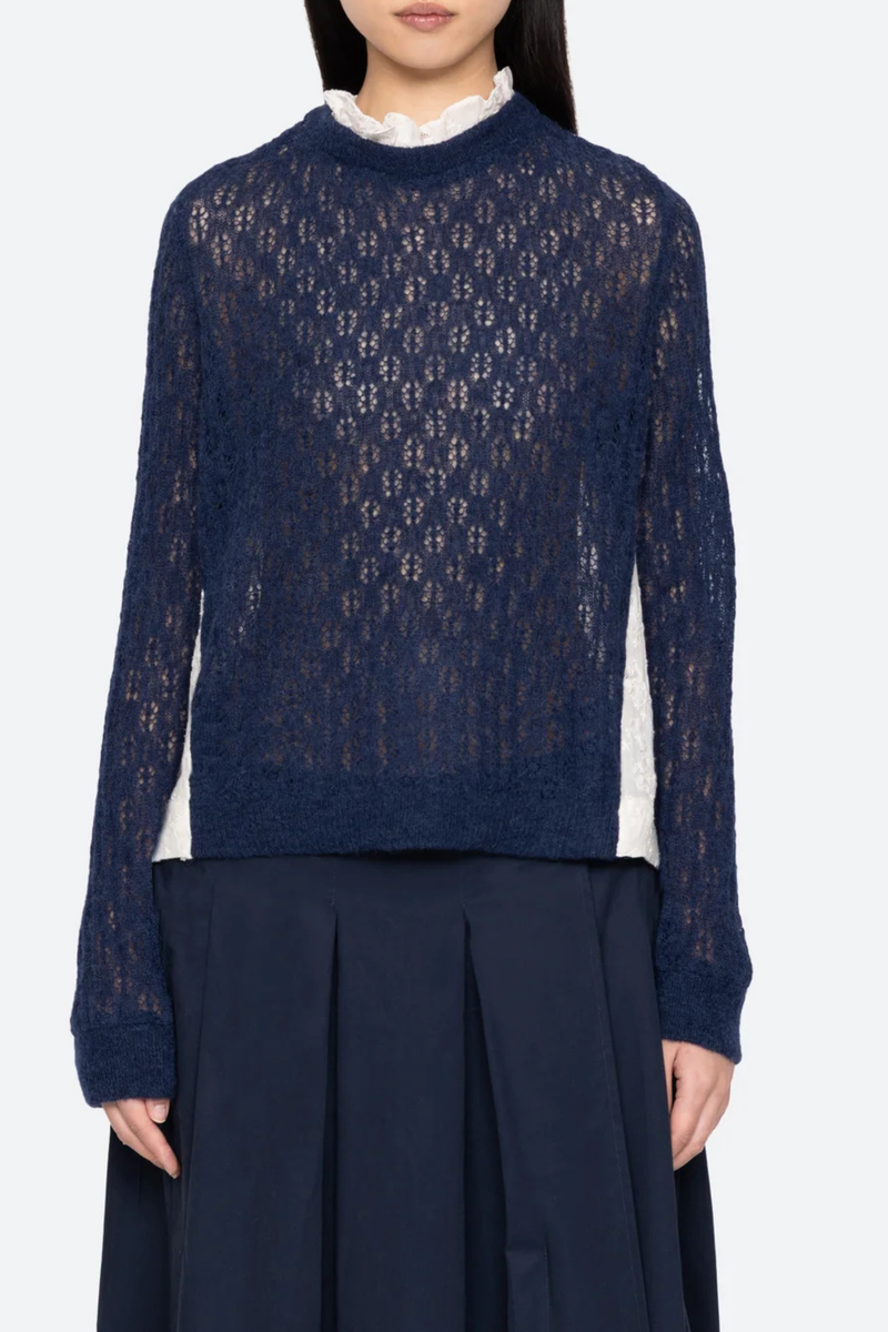 front profile model wearing Teagan Knit Sweater Navy Soft alpaca wool at the front
Intricate embroidery on the back
Delicate ruffle at the collar
Ribbed-knit trim at the cuffs and hem
Self-55% alpaca, 45% polyamide
combo-100% cotton
Button back closure