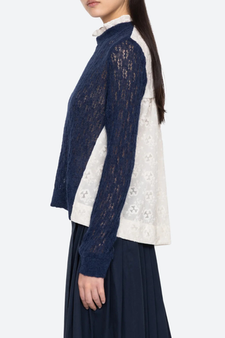 side profile model wearing Teagan Knit Sweater Navy Soft alpaca wool at the front
Intricate embroidery on the back
Delicate ruffle at the collar
Ribbed-knit trim at the cuffs and hem
Self-55% alpaca, 45% polyamide
combo-100% cotton
Button back closure