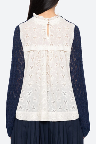 back profile model wearing Teagan Knit Sweater Navy Soft alpaca wool at the front
Intricate embroidery on the back
Delicate ruffle at the collar
Ribbed-knit trim at the cuffs and hem
Self-55% alpaca, 45% polyamide
combo-100% cotton
Button back closure