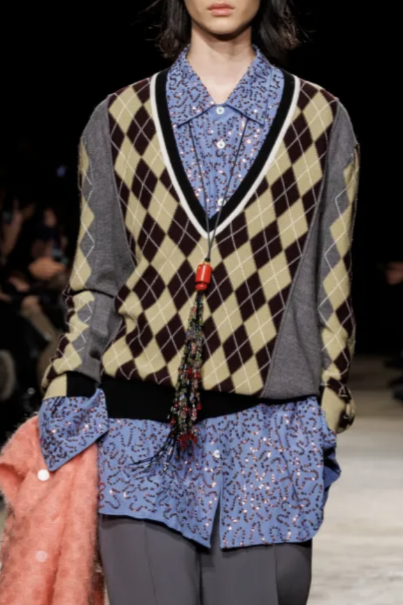 front profile model wearing Teddy Reverse Argyle V-Neck Sweater grey/yellow/pink multi 100% Laine wool
Deep v-neckline
Argyle print throughout
Contrast solid color on hem and side sleeves and collar area
Long sleeves
Relaxed fit