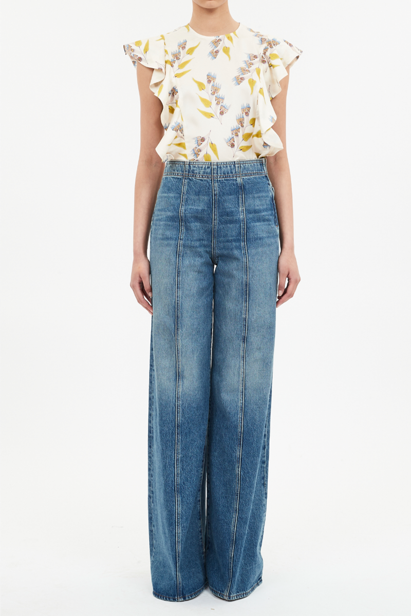 front profile model wearing The Bianca Wide Legs Jeans blue wash with center front raised seam