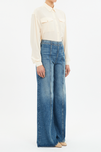 side profile model wearing The Bianca Wide Legs Jeans blue wash with center front raised seam