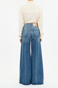 back profile model wearing The Bianca Wide Legs Jeans blue wash with center front raised seam