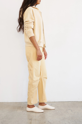 side profile model wearing The Birdie Hoodie butter yellow cotton Luxurious Japanese french terry lining
Piece dyed for a saturated hue that maintains it’s color
Relaxed fit