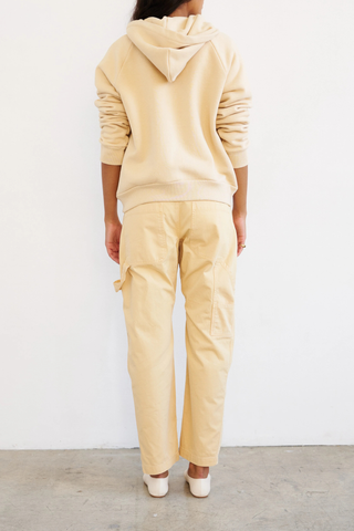 back profile model wearing The Birdie Hoodie butter yellow cotton Luxurious Japanese french terry lining
Piece dyed for a saturated hue that maintains it’s color
Relaxed fit