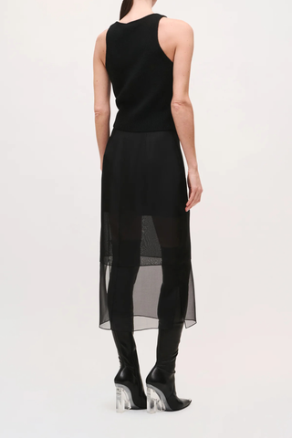back profile model wearing The Brett Pencil Skirt Black  Silk crepe de chine skirt
Sheer silk organza lower panel
Slim pencil silhouette
Midi length
Concealed center back zip closure with hook-and-eye
Baby-hem finish on organza