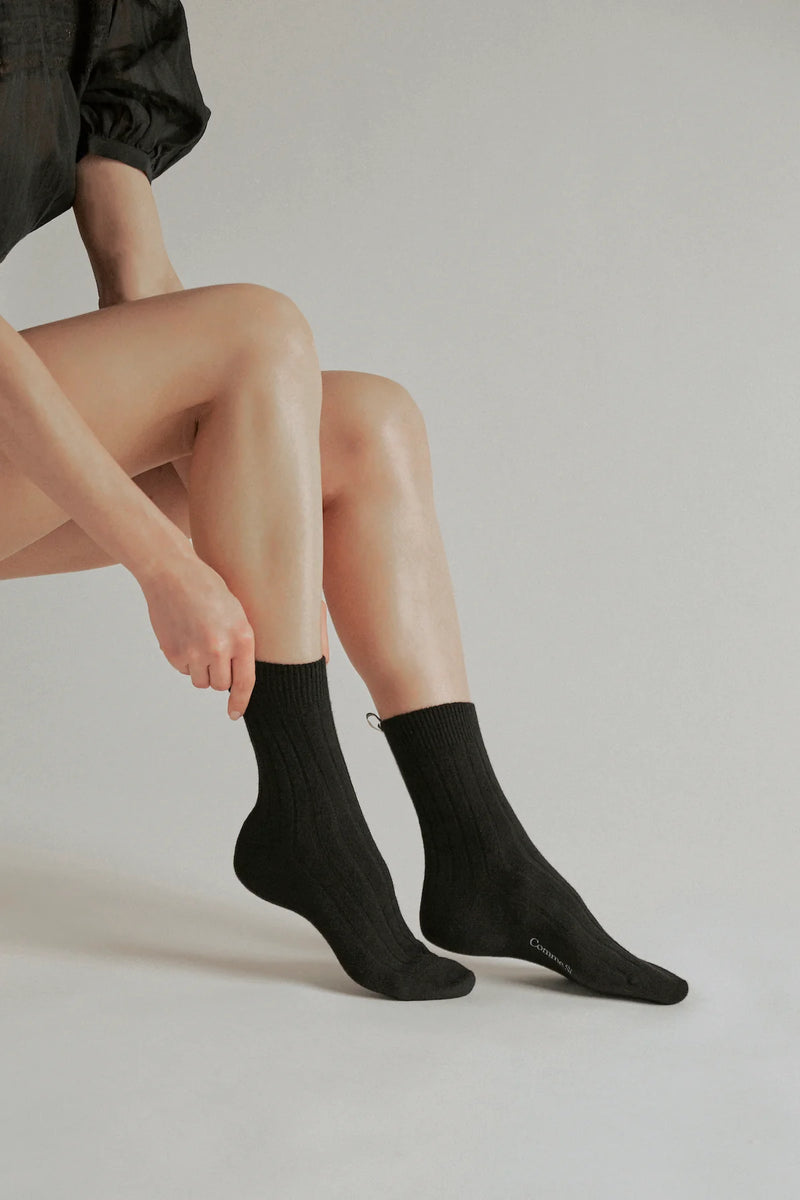 model wearing  The Cashmere Sock Black black cashmere ribbed with logo ribbon tab