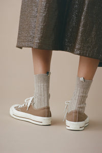 model wearing The Cashmere Sock Oatmeal cashmere ribbed with logo ribbon tab