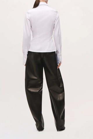 back profile model wearing The Ceci Button Down Fitted Shirt white Pointed collar
Long sleeves
Subtle shaping through the waist
Button-front closure
Tailored silhouette
Curved hem falls slightly lower at the back

Shaped waist
100% cotton