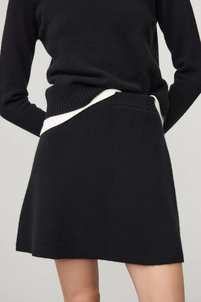 front profile model wearing The Clare Skirt Black cashmere mini length regular fit slightly flared elastic waistband