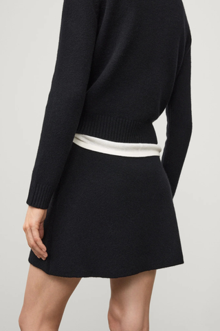 back profile model wearing The Clare Skirt Black cashmere mini length regular fit slightly flared elastic waistband