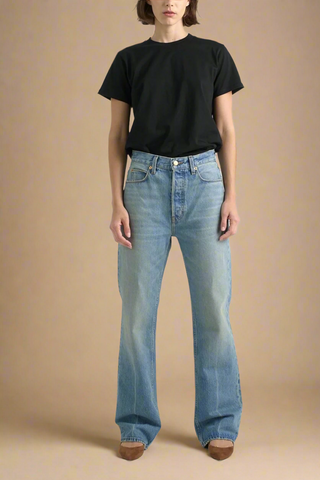 front profile model wearing the easy mid-rise, relaxed fit, straight leg jean in worn indigo