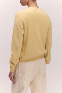 back profile model wearing The Enya Cashmere/Cotton Cardigan pale yellow, crewneck, ribbed hem and cuff, button front closure