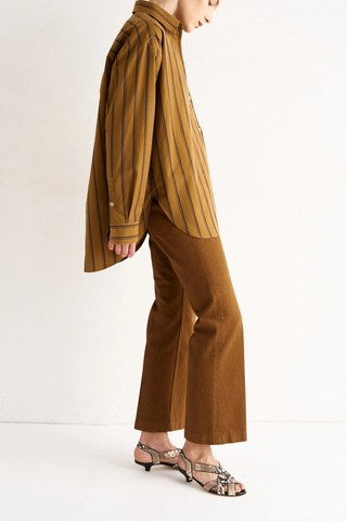 side profile model wearing The Essential Striped Shirt golden rod yellow Relaxed fit
Beautiful drape
Perfectly placed button at the chest ,
Button just under the collar,
Small button perfectly placed on the cuff placket
93% Cotton 7% Silk