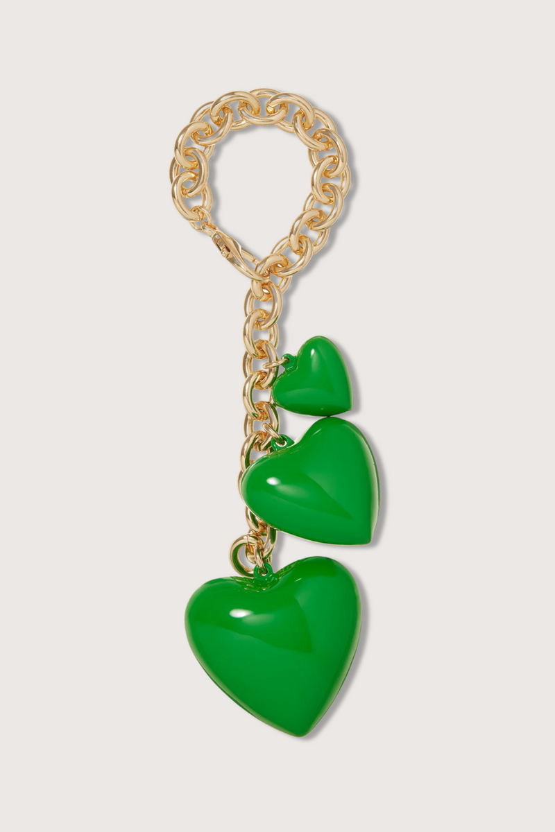flat lay The Happy Bag Charm Green puffy heart with gold chain
