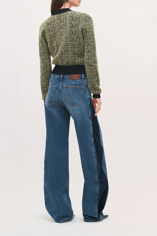 back profile model wearing The Lana Trouser Denim bi-color blue mid wash
Wide-leg
Split seam construction
Integrated side pleats 
Classic five-pocket construction
Back darts in place of a traditional denim yoke
Brown denim back patch
Zip fly with button closure
100% Cotton
