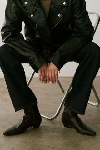 model wearing The Lennon Boot leather upper black elongated toe cuban stacked leather heel