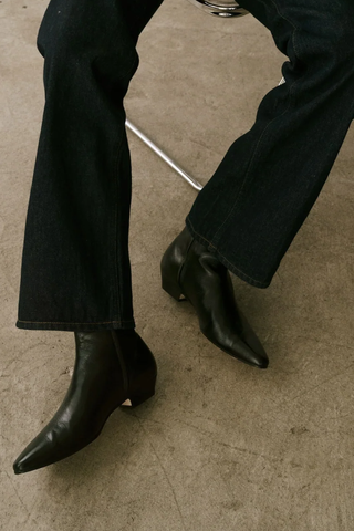 model wearing The Lennon Boot leather upper black elongated toe cuban stacked leather heel