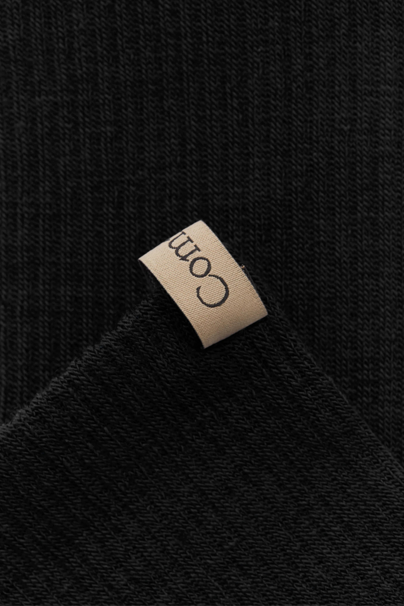 close up pull tab detail for The Merino Tube Sock Black Tube sock
Comfort and performance
68% Merino Wool, 30% Nylon, 2% Elastane
Terry cushioned footbed
With logo ribbon tab