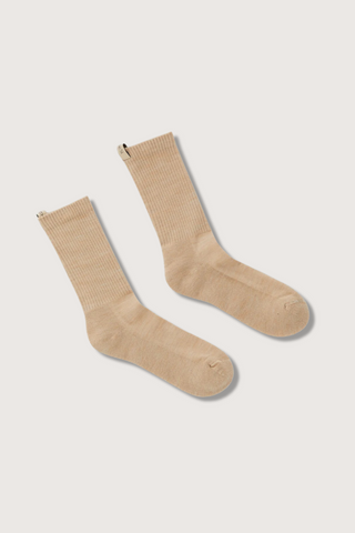 flat lay The Merino Tube Sock Camel wool tube style with decorative logo ribbon tab