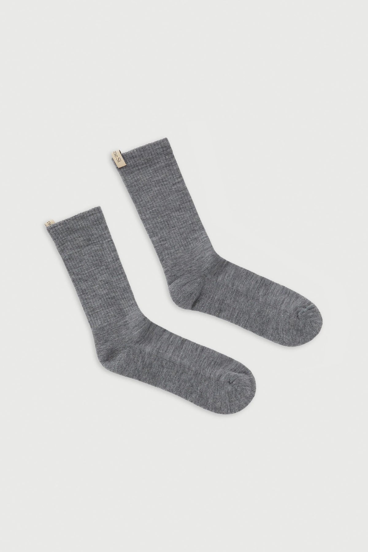flat lay The Merino Tube Sock Heather Grey With logo ribbon tab