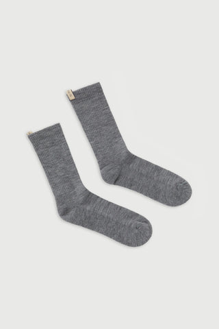flat lay The Merino Tube Sock Heather Grey With logo ribbon tab