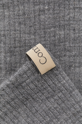 close up ribbon detail tab for The Merino Tube Sock Heather Grey With logo ribbon tab