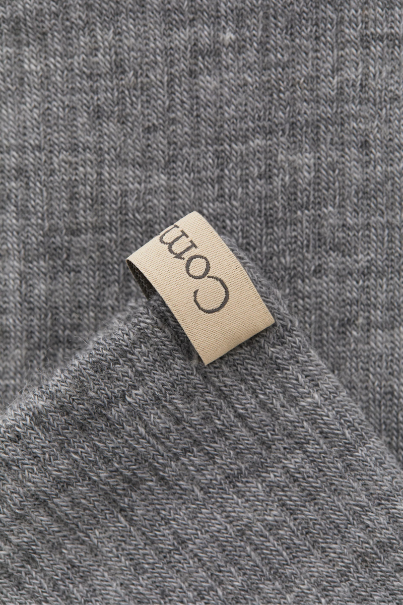 close up ribbon detail tab for The Merino Tube Sock Heather Grey With logo ribbon tab