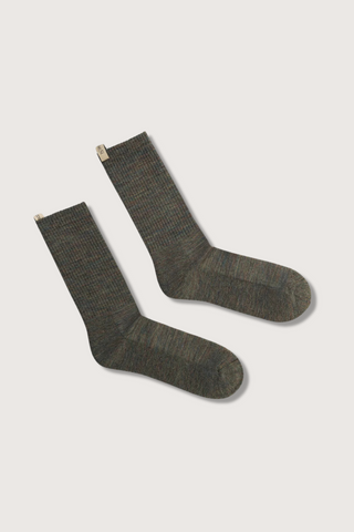 flat lay The Merino Tube Sock Moss Melange wool tube style with decorative logo ribbon tab
