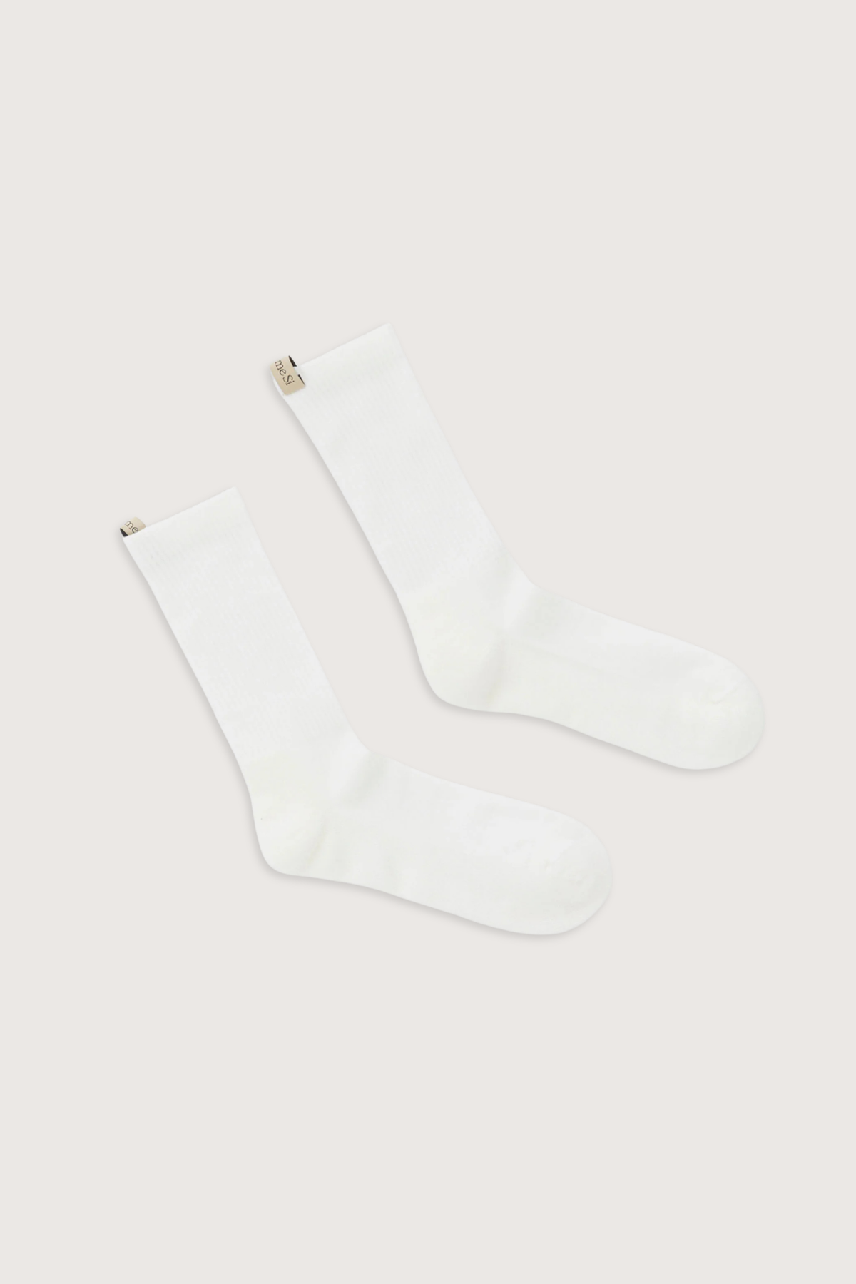 flat lay The Merino Tube Sock Off White 
68% Merino Wool, 30% Nylon, 2% Elastane
Terry cushioned footbed
With logo ribbon tab