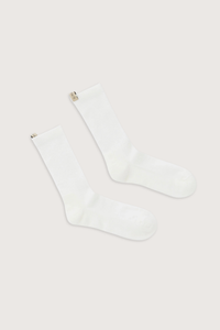 flat lay The Merino Tube Sock Off White 
68% Merino Wool, 30% Nylon, 2% Elastane
Terry cushioned footbed
With logo ribbon tab