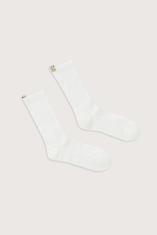 flat lay The Merino Tube Sock Off White 
68% Merino Wool, 30% Nylon, 2% Elastane
Terry cushioned footbed
With logo ribbon tab