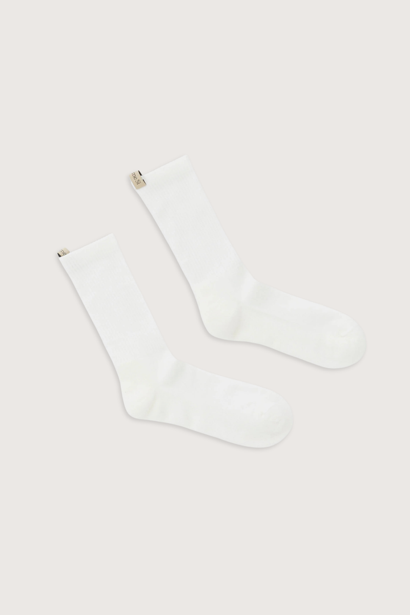 flat lay The Merino Tube Sock Off White 
68% Merino Wool, 30% Nylon, 2% Elastane
Terry cushioned footbed
With logo ribbon tab