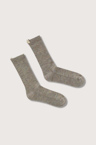 flat lay The Merino Tube Sock Rainbow Melange wool tube style with decorative logo ribbon tab