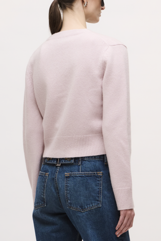 back profile model wearing  The Sloane Cardigan Dusty Pink V-NECKLINE
4 BUTTON CLOSURE
14% SILK, 86% CASHMERE