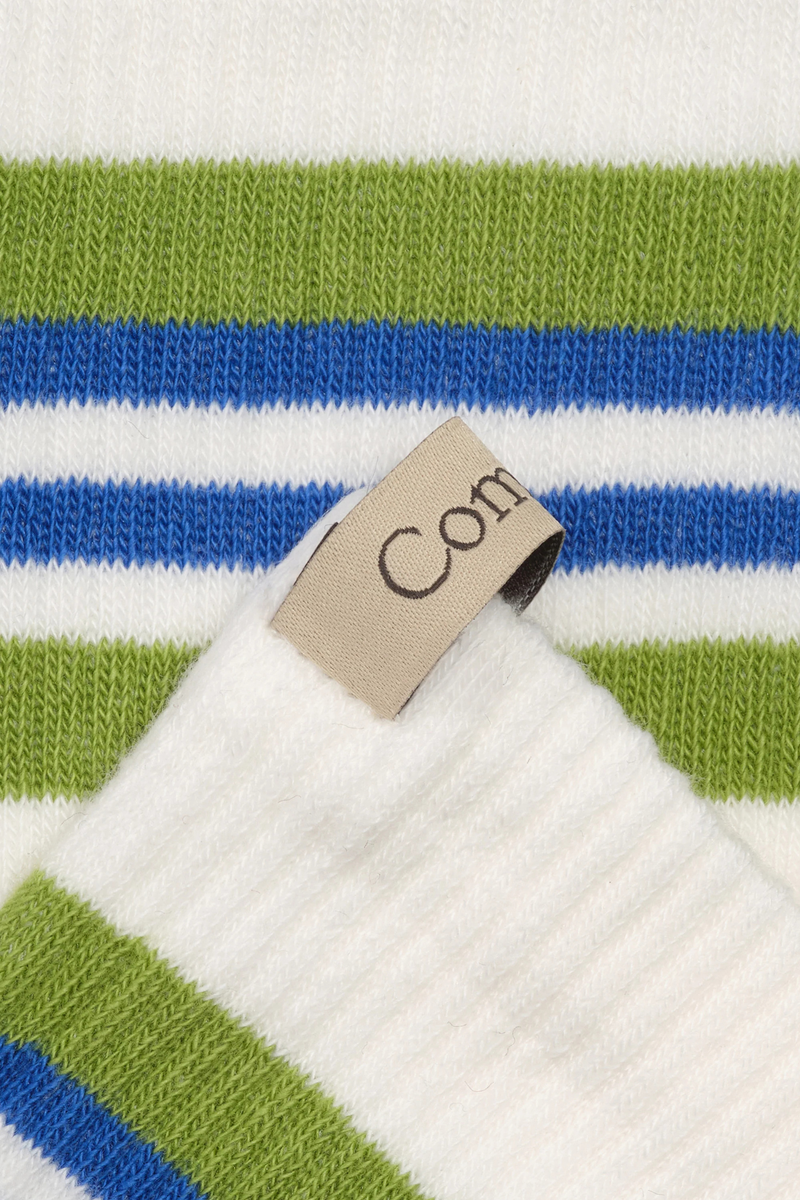 close up ribbon and stripe detail for The Tube Sock - Egyptian Cotton Grass/Blue Bold stripes
Terry cushion footbed
Medium weight
Reinforced toe
Finished by hand with decorative logo ribbon