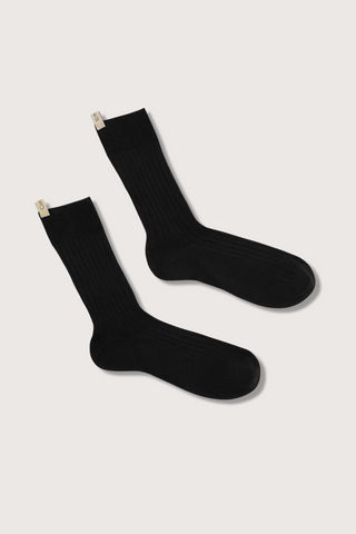 flat lay The Yves Sock Black Egyptian cotton wide rib with decorative logo ribbon tab