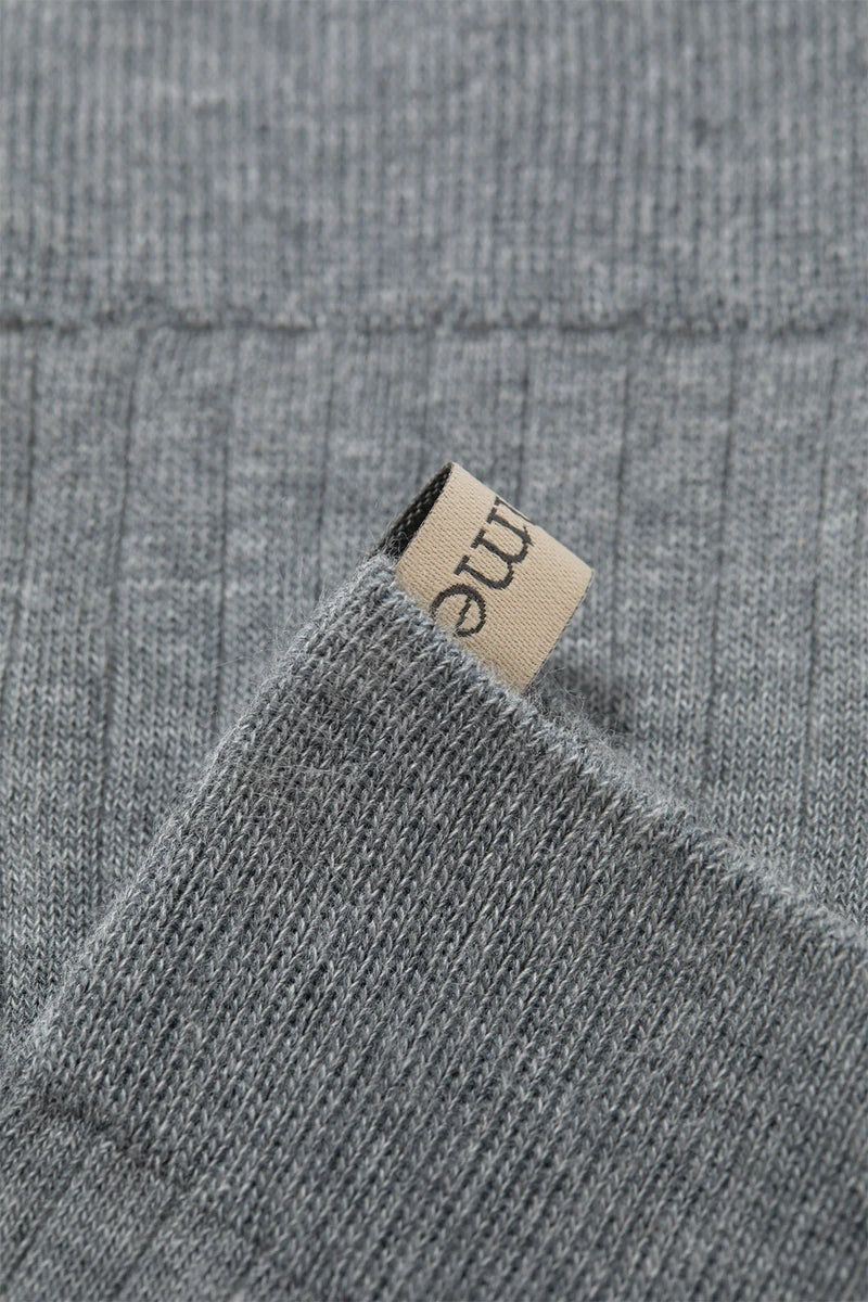 close up of logo ribbon tab for The Yves Sock Heather Grey cotton ribbed