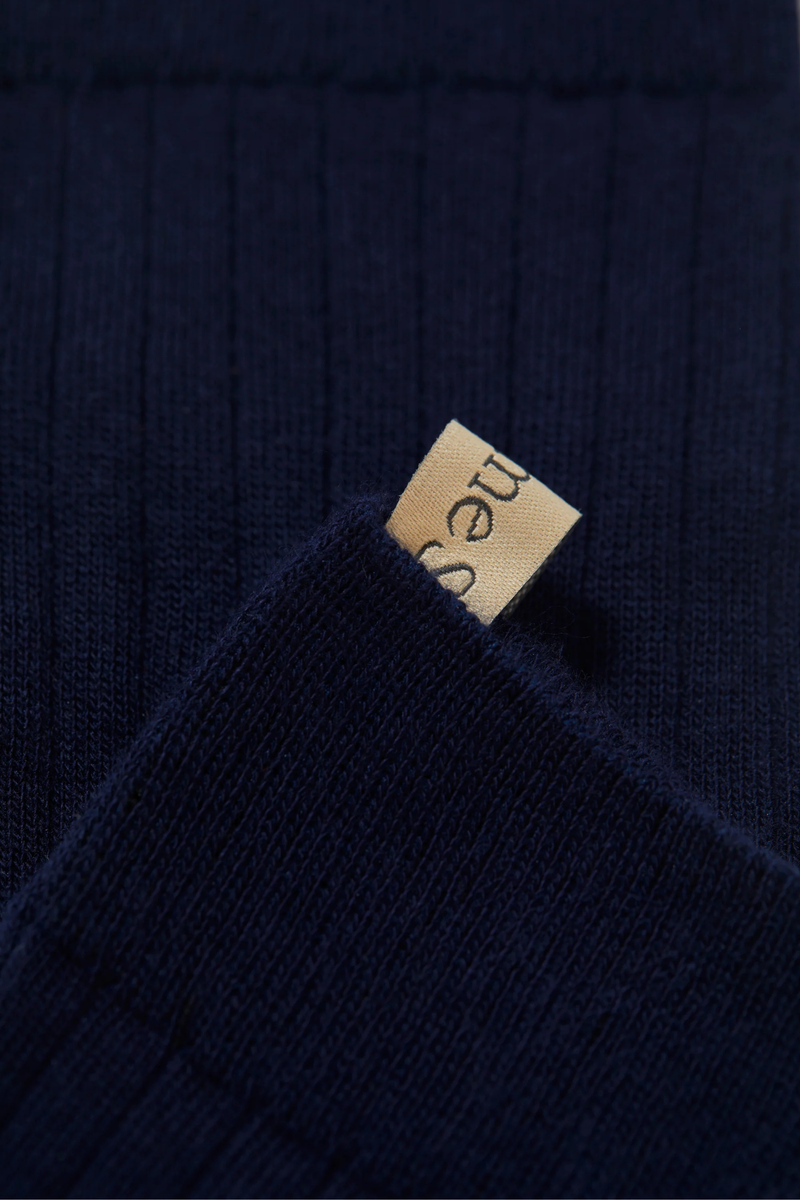 close up pull tab detail for The Yves Sock Navy Egyptian Cotton
Not too thin, not too thick
Wide rib
Plenty of stretch
78% Cotton + 22% Polyamide
Reinforced toe
Hits above the ankle
Finished by hand with decorative logo ribbon
