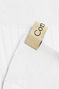 close up of logo tab for The Yves Sock White cotton ribbed