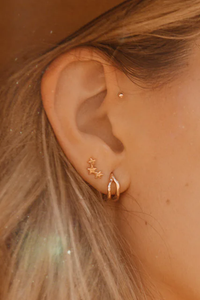 model wearing Three Twinkling Star Earring 14k gold