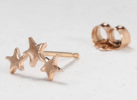 flat lay Three Twinkling Star Earring with the connecting support 14k gold