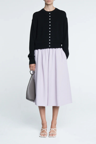 front profile model wearing Tiny Button Cardigan Black Relaxed fit
Drop shoulder tiny shell buttons at the center front
Long sleeve cardigan
 Cashmere  Cotton blend