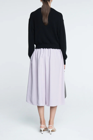 back profile model wearing Tiny Button Cardigan Black Relaxed fit
Drop shoulder tiny shell buttons at the center front
Long sleeve cardigan
 Cashmere  Cotton blend