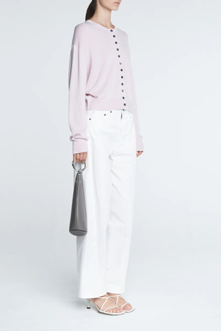 side profile model wearing Tiny Button Cardigan Powder Pink Relaxed fit
Drop shoulder
Multiple contrasting, tiny shell buttons at the center front
Long sleeve cardigan
Cashmere Cotton blend