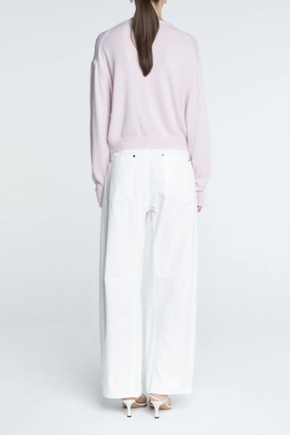 back profile model wearing Tiny Button Cardigan Powder Pink Relaxed fit
Drop shoulder
Multiple contrasting, tiny shell buttons at the center front
Long sleeve cardigan
Cashmere Cotton blend