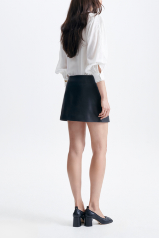 back profile model wearing Tolmia Leather Mini Skirt noir Slightly A-line silhouette
Back darts
Aged-brass-tone metal zip
100% lambskin (chrome-free tanning); lining 100% viscose
