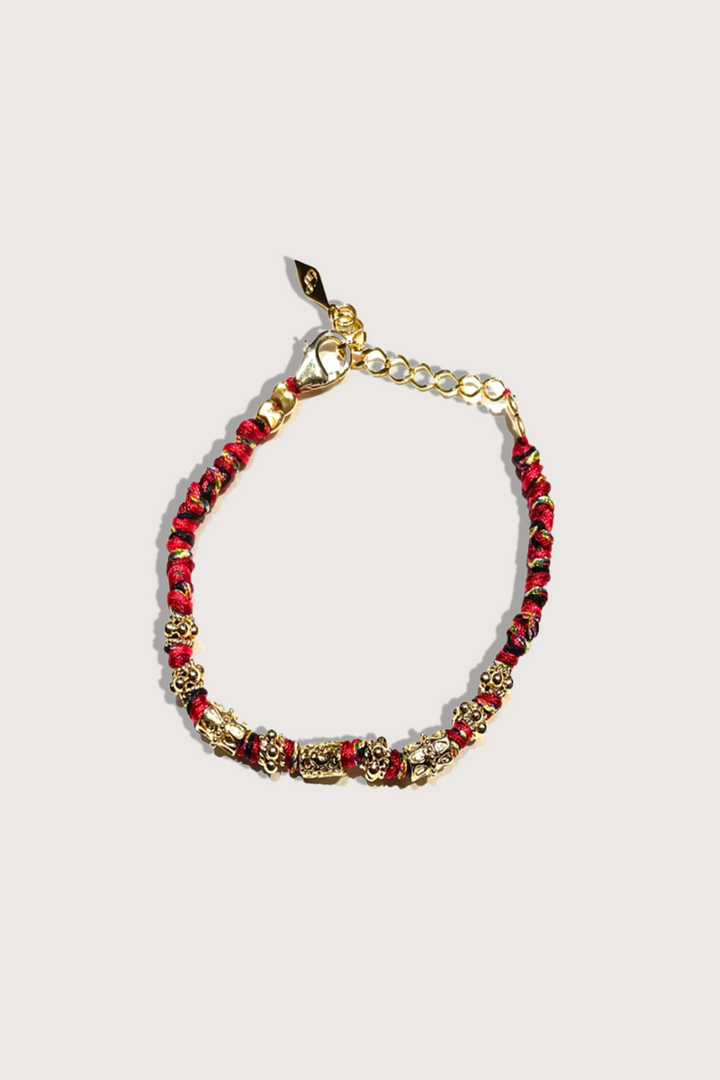 flat lay Tosca Bracelet red Hand crocheted bracelet with engraved 18K gold-plated beads