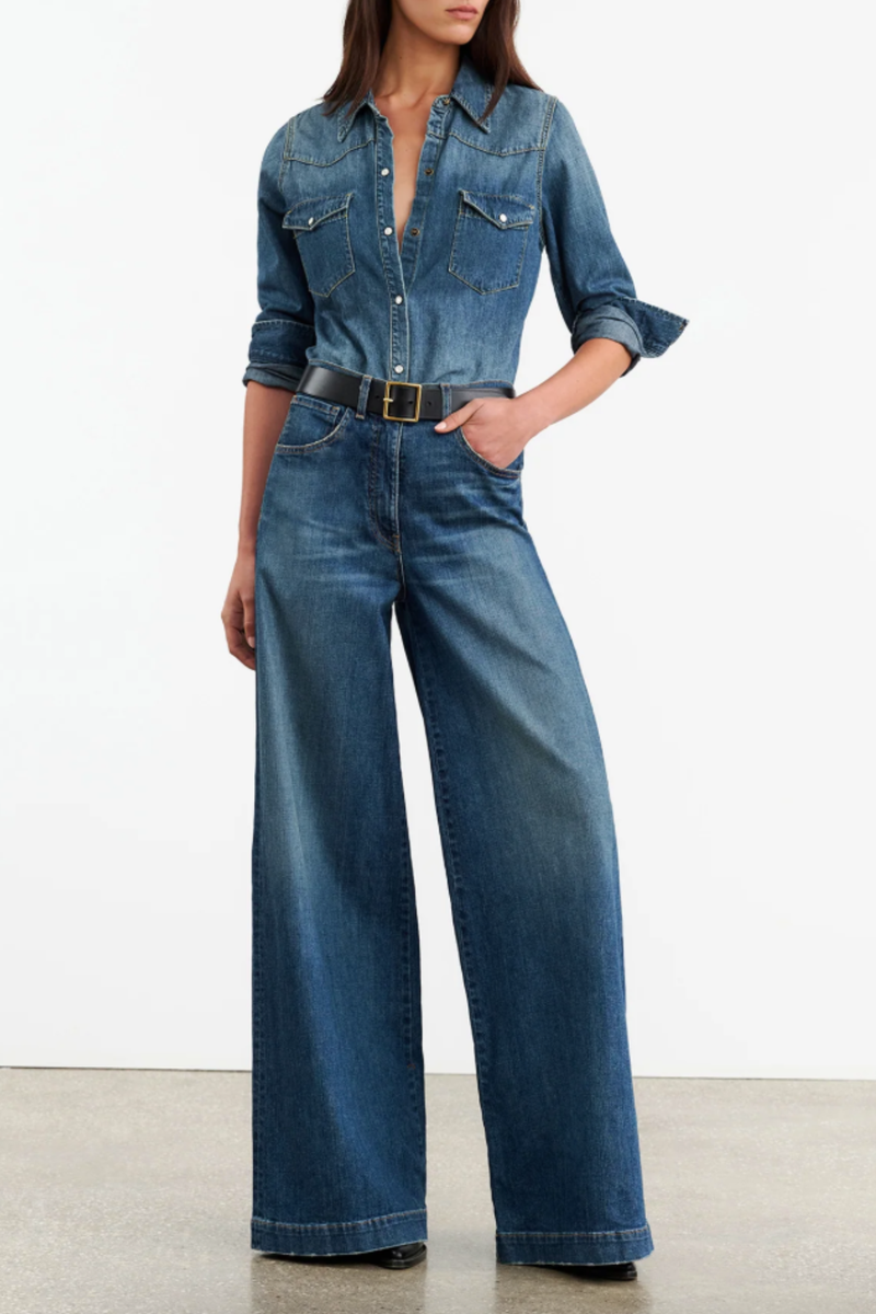 front profile model wearing Travis Denim Shirt medium blue wash classic straight fit collar jean shirt center front pockets