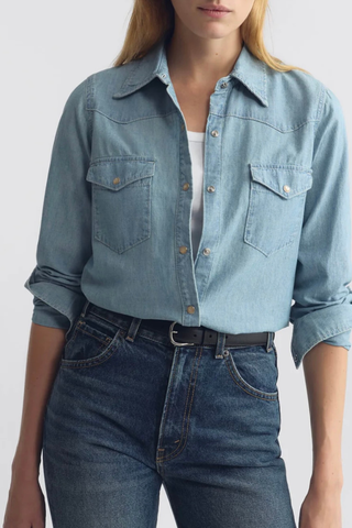 Front profile model wearing Travis shirt chambray indigo Classic denim shirt
Pearl snaps
Classic Western details
100% Cotton light-weight denim